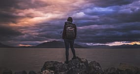 standing behind a lake
